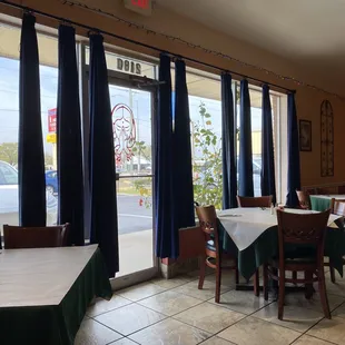 a view of a restaurant with tables and chairs