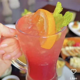 a person holding a glass of drink