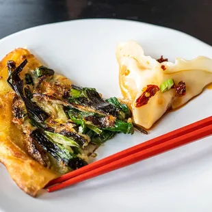 a plate of food with chopsticks