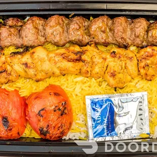 a tray of food with meat and rice