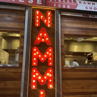 a neon sign in front of a restaurant