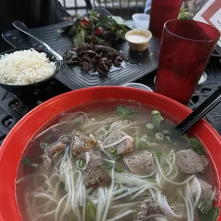 Pho with combination (brisket, meatball and beef). Shaking Beef is in the background.