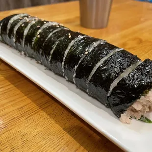 a sushi roll on a white plate