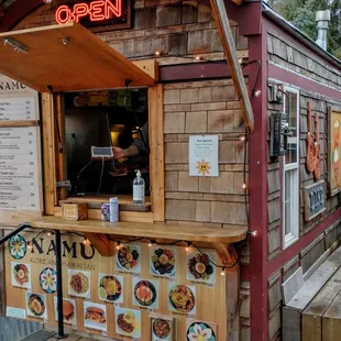 Flip up window covering keeps customers dry when ordering