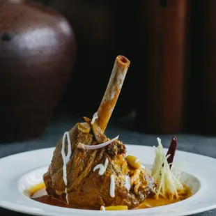 Slow-braised lamb shank simmered in northern Thai red curry, peanuts, potatoes and ginger