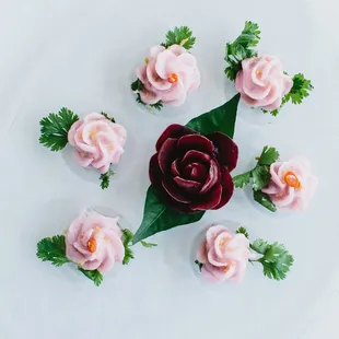 Steamed tea rose dumplings with caramelized palm sugar, minced chicken, ground peanuts, and pickled radish