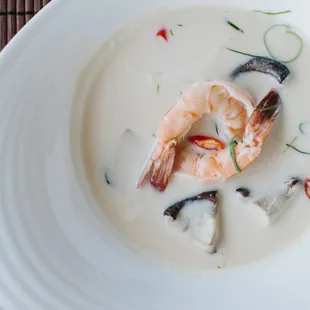 Shrimp in silky coconut galangal soup with young coconut meat, shiitake and straw mushrooms