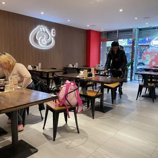 a woman sitting at a table in a restaurant
