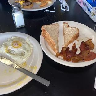 Eggs bacon and side of toast ,  breakfast served all day