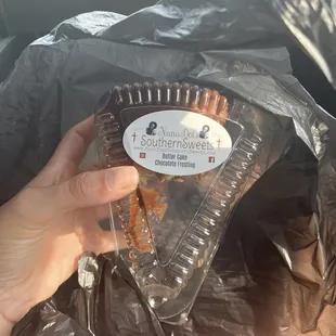 a hand holding a plastic container