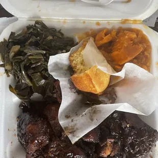 Large plate with bourbon chicken, collard greens, candied yams, and cornbread.
