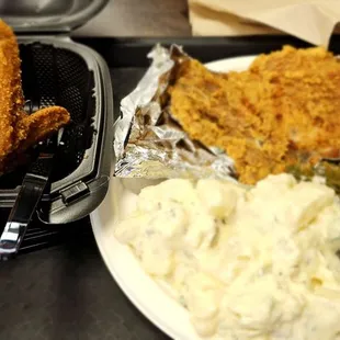 Fried pork chop, potato salad, collard greens and a wing
