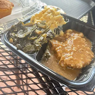 Smothered pork chop, greens and Mac &amp;cheese was BOMB! Prices are a bit hey  but serving sizes of the sides made it worth it.