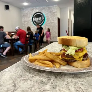 The Patriot - our largest burger featuring two beef patties, bacon, cheese, lettuce, and tomato served on Texas toast