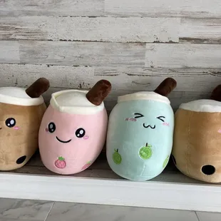 a row of plush tea cups