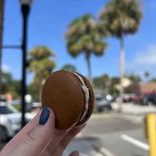 a hand holding a pastry