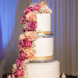 a wedding cake decorated with flowers