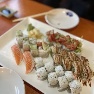 a plate of sushi and chopsticks