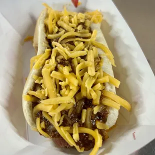 a hot dog covered in cheese