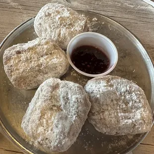 NEW ORLEANS STYLE BEIGNETS Served with powdered sugar and peach raspberry marmalade or cream cheese glaze