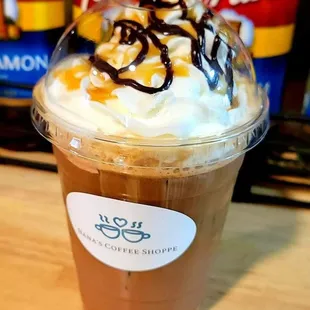 a cup of coffee with whipped cream and caramel