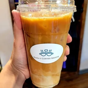 a hand holding a cup of coffee