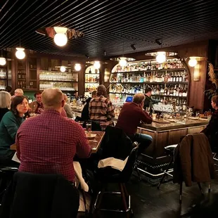 a large group of people sitting at a bar