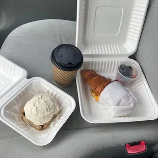 Free coffee, homemade cinnamon roll, bacon breakfast sandwich on a croissant and side of berries!