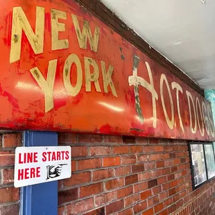 a sign on a brick wall