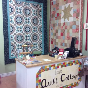 Pretty quilts behind the counter.