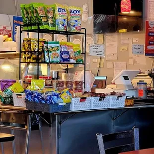 Next to the drinks refrigerator is the cash register.