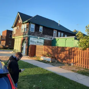 a man standing in front of a house