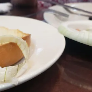 a bagel with onions and olives