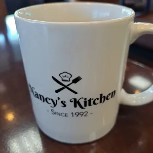 a coffee mug with a knife and fork on it