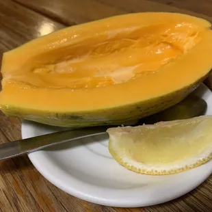 a half of a melon and a slice of lemon