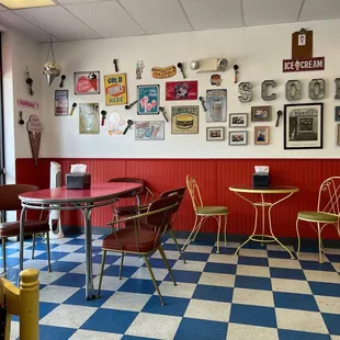 a checkerboard floor with chairs and tables