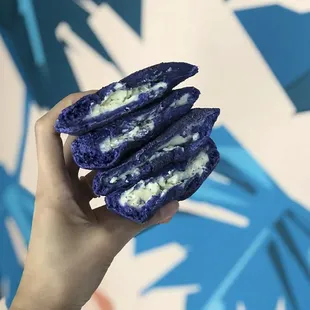 a hand holding a sandwich