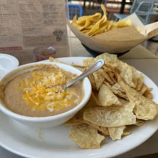 Spicy bean dip with taco shell chips (I think)