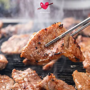 the meat being cooked on the grill