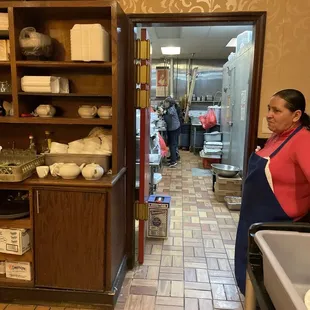 a woman standing in a kitchen