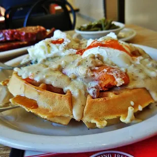 a plate of waffles with cheese and sauce