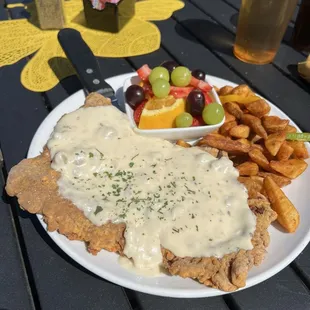 Generous size chicken fried steak! With breakfast potatoes and fruit.
