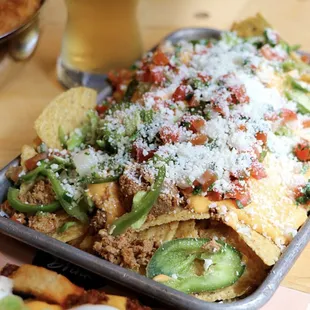 Chorizo, pickled jalapeño, and cojita cheese pair with cool salsa fresca to give these crunch tortolla chips a kick.