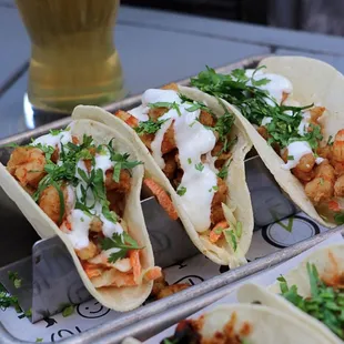 Shrimp Tacos -- cumin chili wild shrimp, cabbage claw, lime and chili crema, cilantro