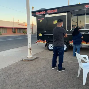 a man standing in front of a food truck