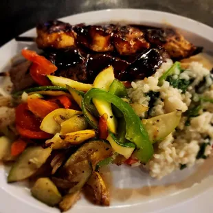 Two meat grilled kabob with vegetables and risotto.