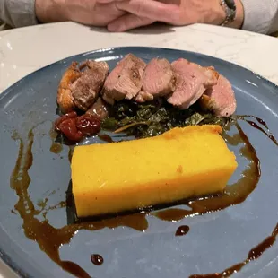 Duck breast with crispy polenta cake Swiss chard and cherry gastrique