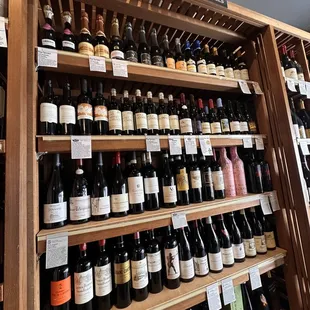 a shelf of wine bottles