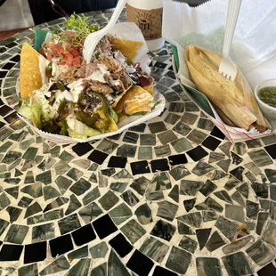 a plate of food on a mosaic table
