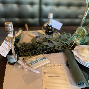 a table with a bottle of wine and a menu